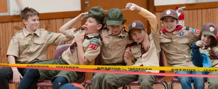 Pack 275 Scouts sitting together at an indoor event